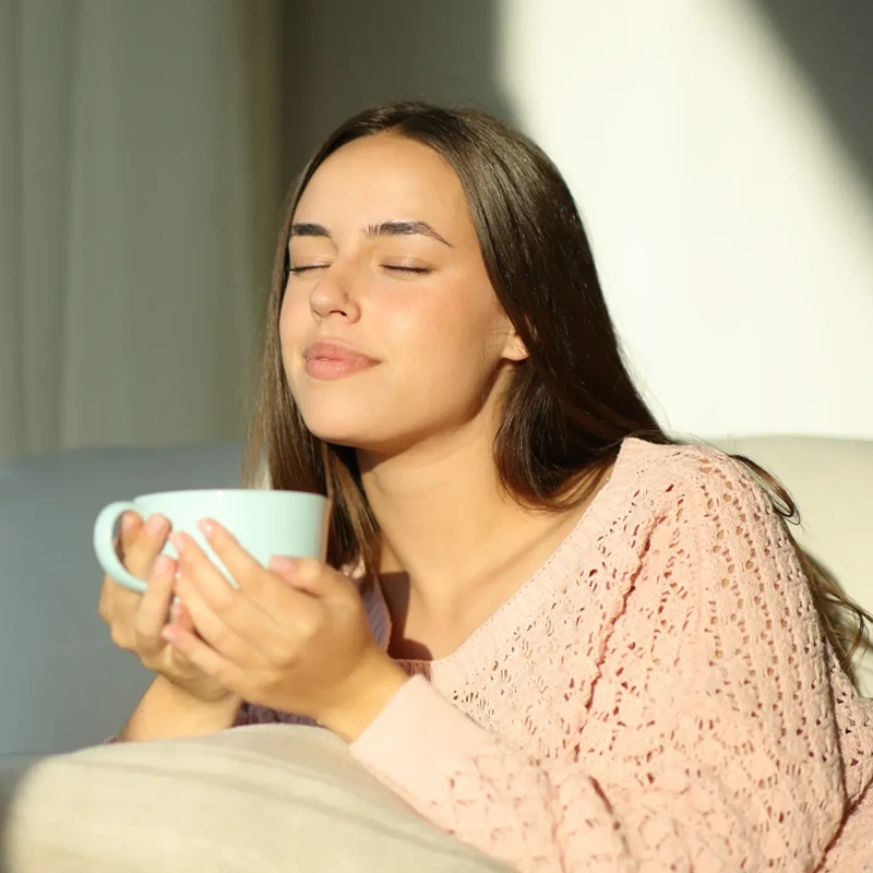 Woman holding a mug with her eyes closed – online psychiatry in Los Angeles, CA
